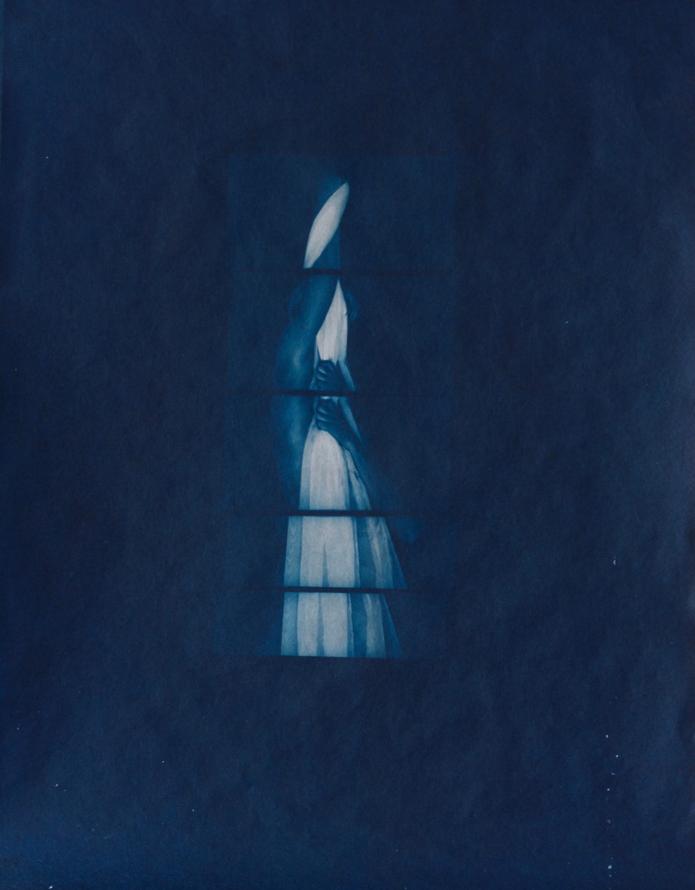 A narrow arrangement of pale body fragments against a deep blue field