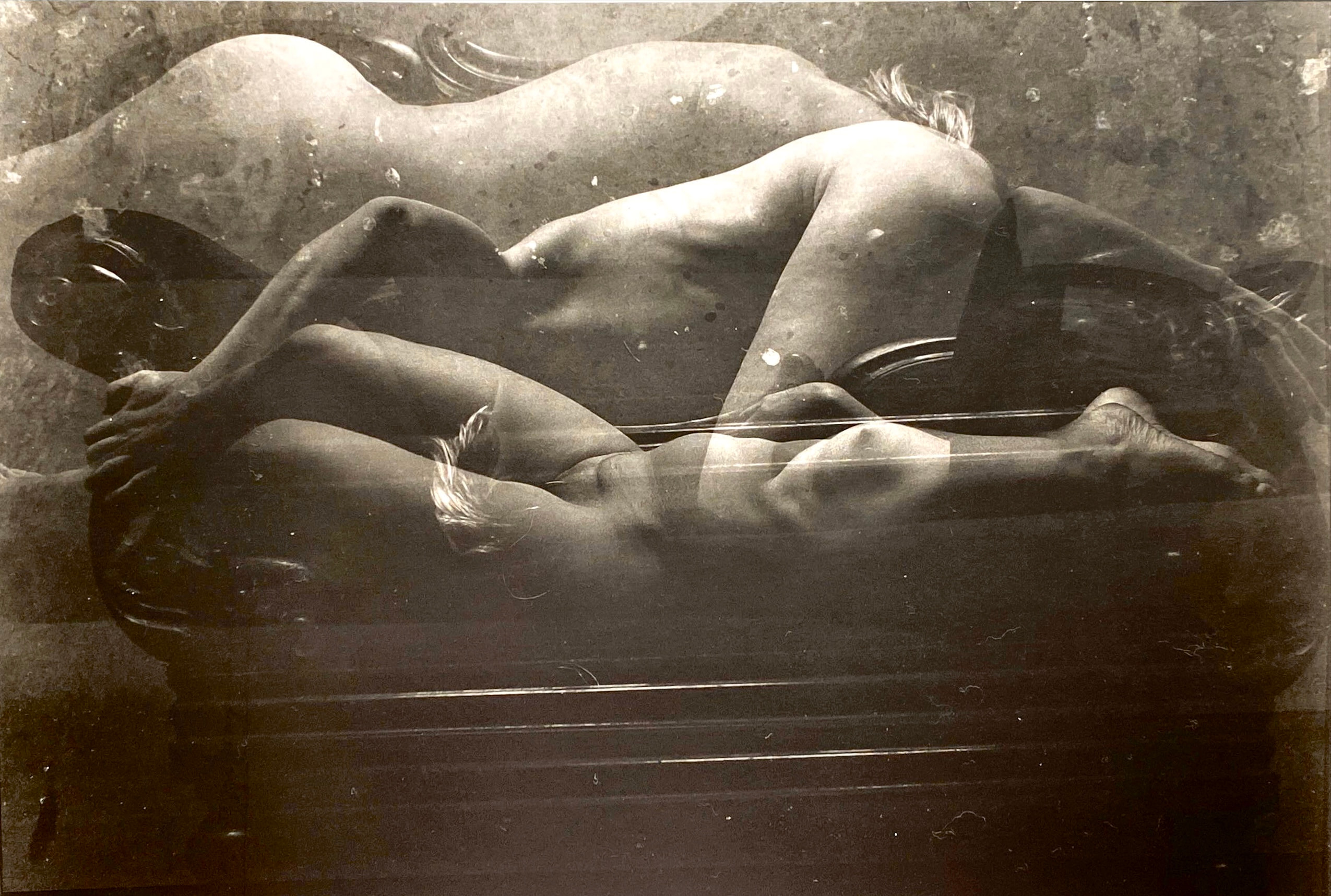 Layered monochrome impressions of a reclining figure on a couch