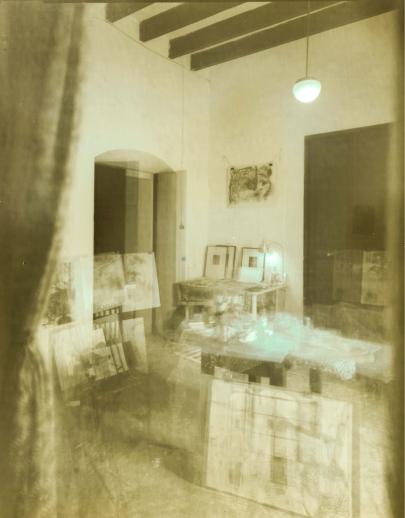Interior with exposed ceiling beams, a glowing pendant light and overlapping furniture